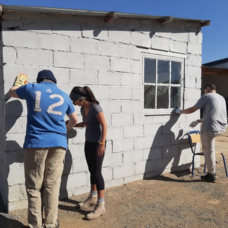 students painting a wall