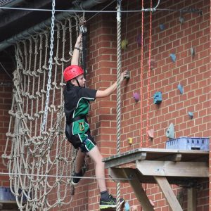 student doing rock climbing