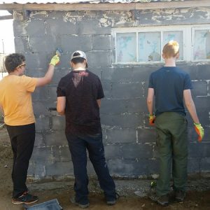 students painting a wall