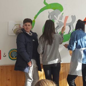 students painting a wall