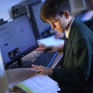 boy studying and using computers