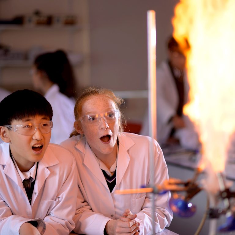 students in class watching a flame