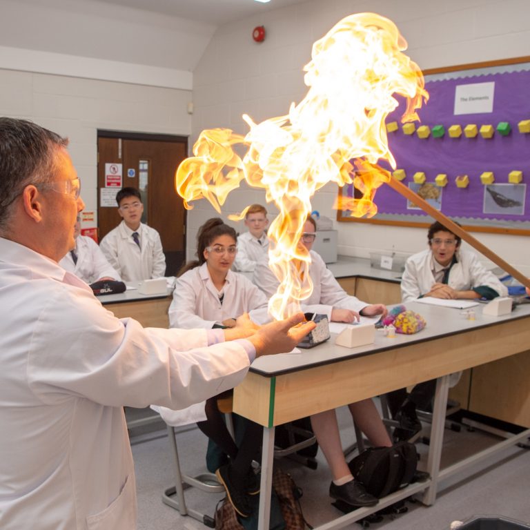 teacher's hands on fire for an experiment
