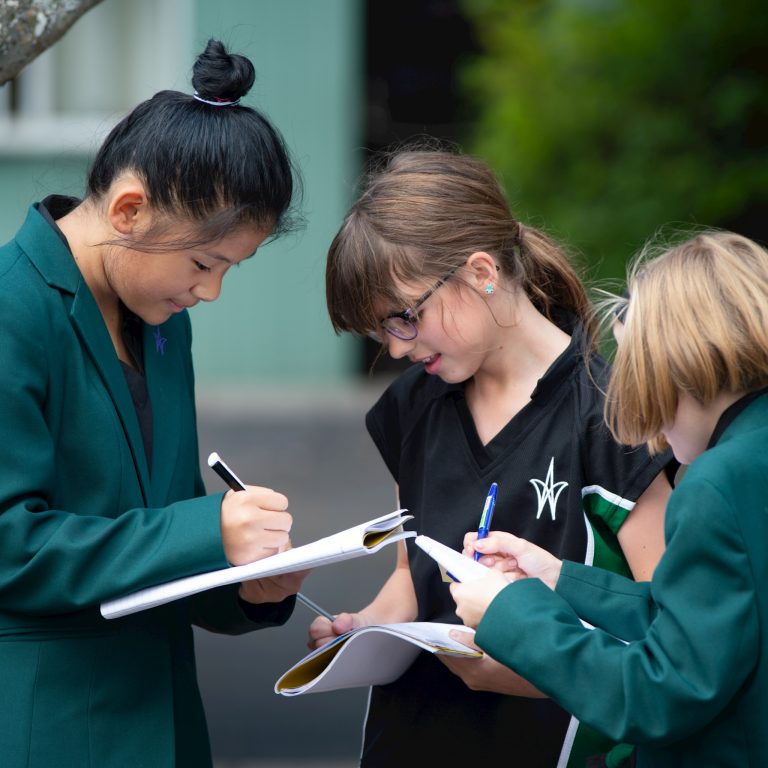 students writing into their booklets