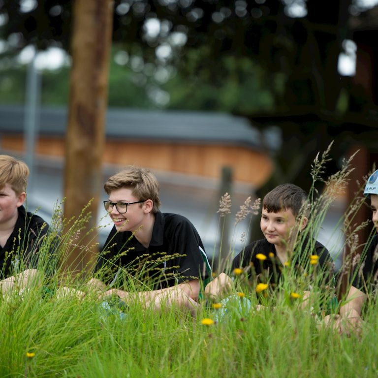 students sat on grass