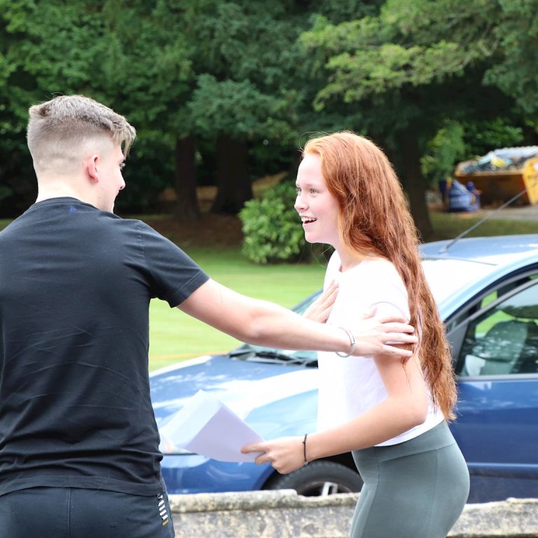 students smiling with their exam results