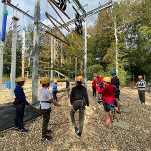Students climbing up the obstacle course