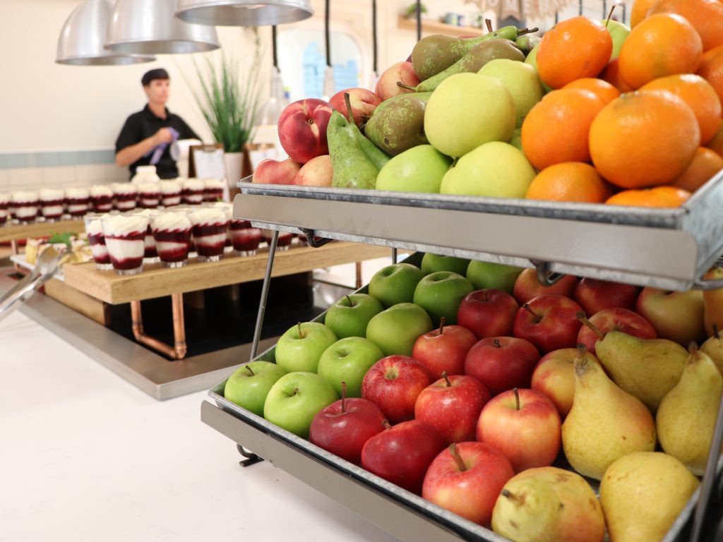 rows of fruit - apples, pears and oranges, with desserts to the left