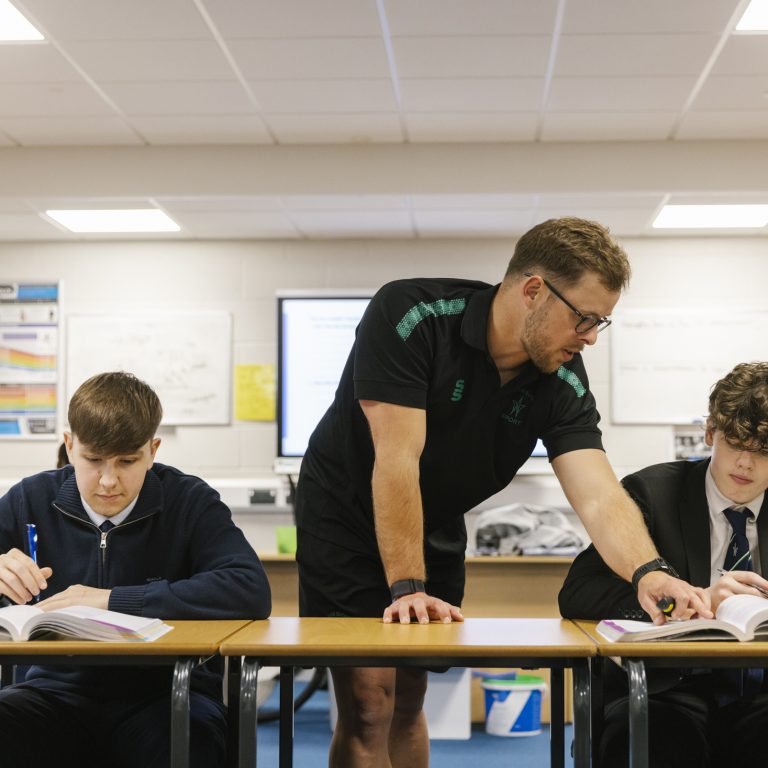 teacher helping a student with his work