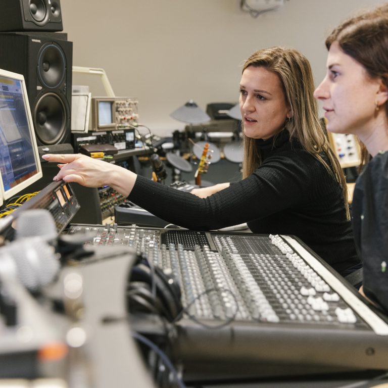 teachers looking at recording equipment