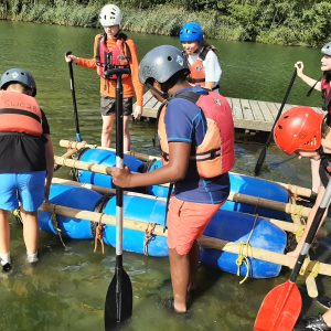 children climbing off a raft