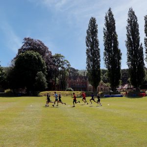 children running through a field