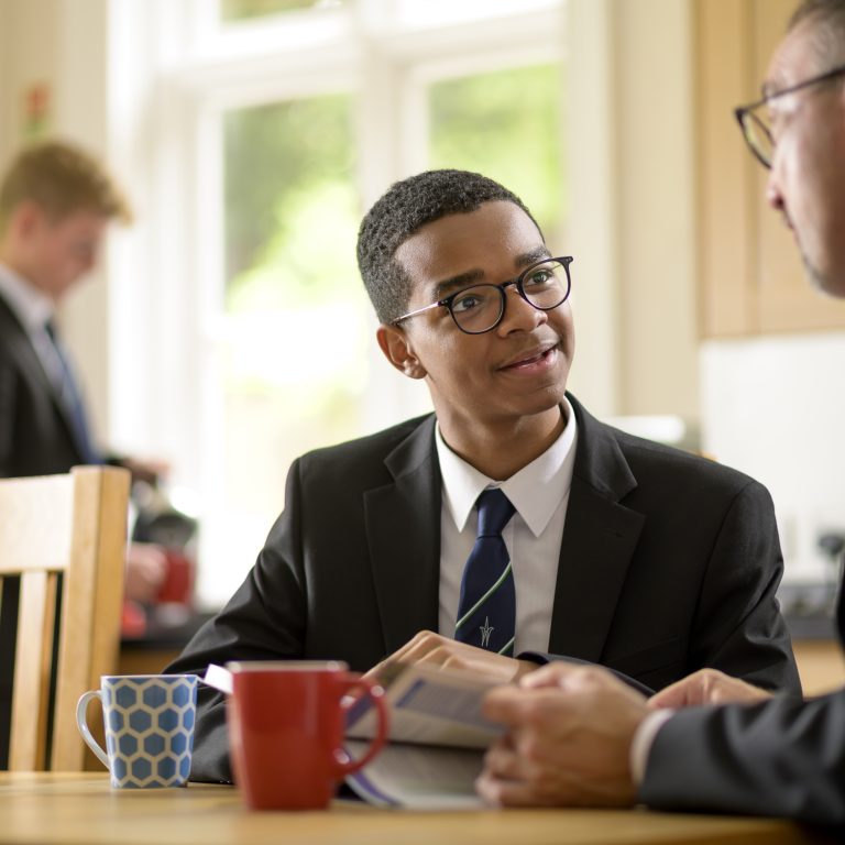 boy looking at teacher