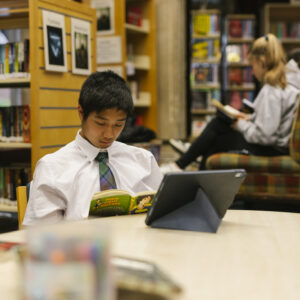 boy reading a book in the library